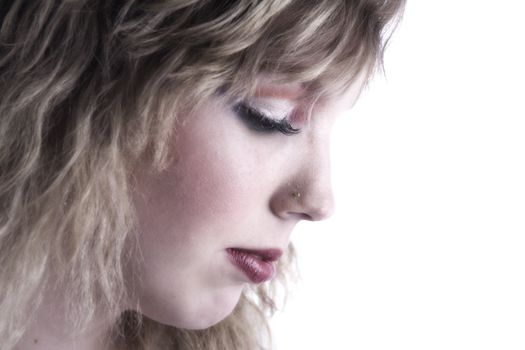 Studio portrait of a curly blond female