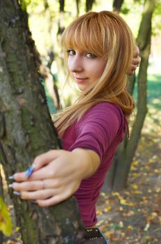 slim cute blond girl in the autumn park