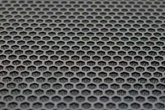 background of hexagonal pattern of speaker grille. selective focus.