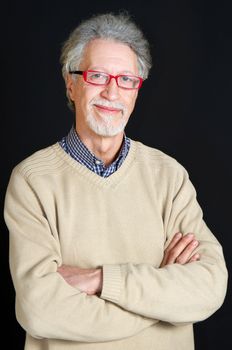 Portrait of a happy mature man isolated on black background 