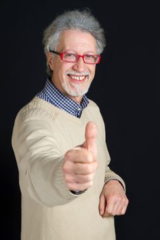 Portrait of a happy mature man isolated on black background 