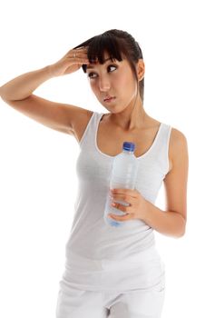 Young exhausted woman holding a bottle of water after workout.