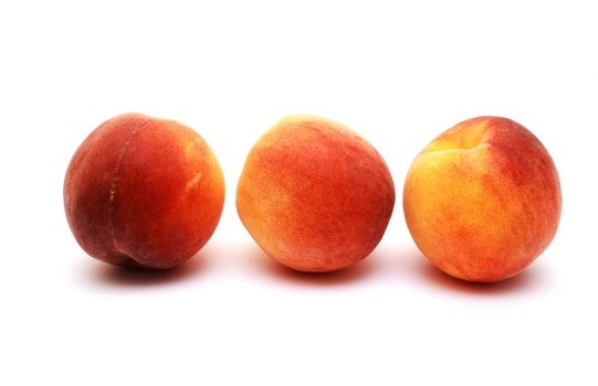 Foto of  three peaches placed on white background