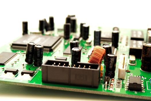 Zoomed foto of green computer circuit board transistors