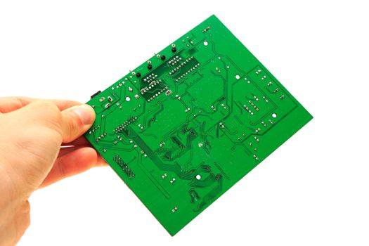 Human hand fingers holding green computer circuit board