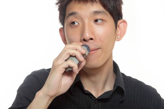 young man shaving his beard off with an electric shaver 