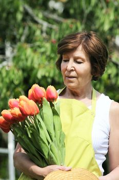 Senior woman holding gardening taking start-ups in his hands