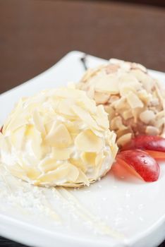 Dessert set of ice-cream with almond, chocolate and grapes