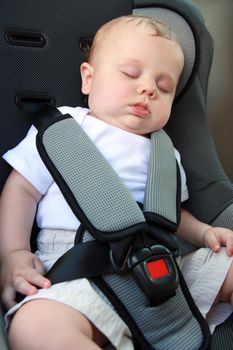 little baby sleeping peacefully in the car seat