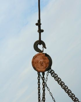 Rusty chains hanging on blue sky