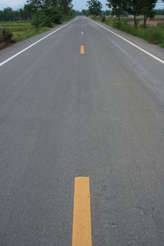 A winding road going through a farm