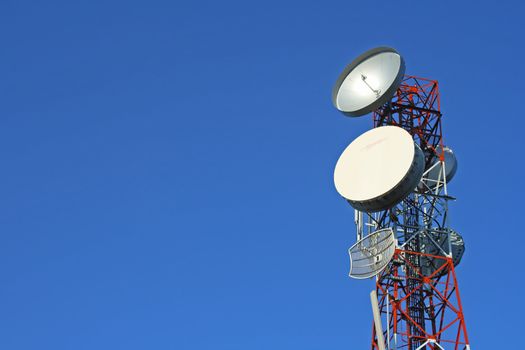 Communication tower over a blue sky