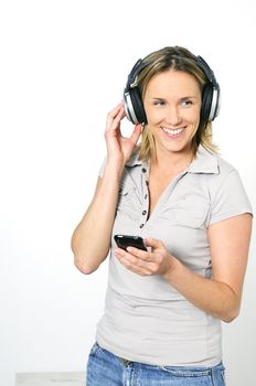 young blond womans listening music with technologic headphones