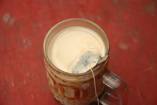 hot tea with milk on porcelain glass