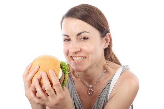 Young woman eating hamburger over white background