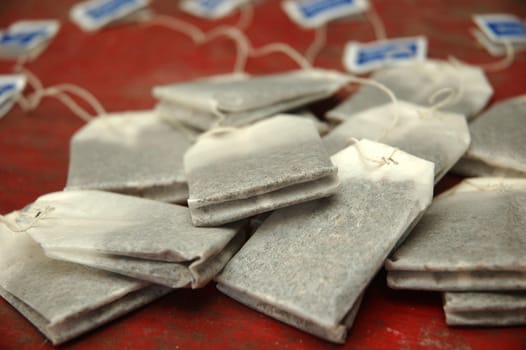 bunch of tea bags isolated on red background