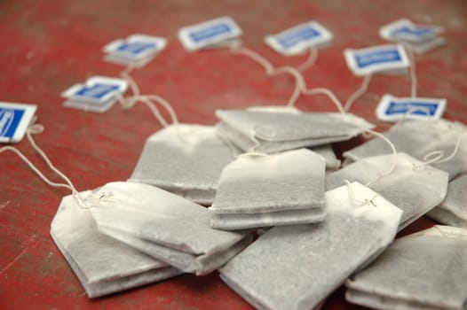 bunch of tea bags isolated on red background