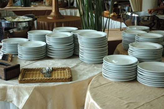 stack of white plates that used in party