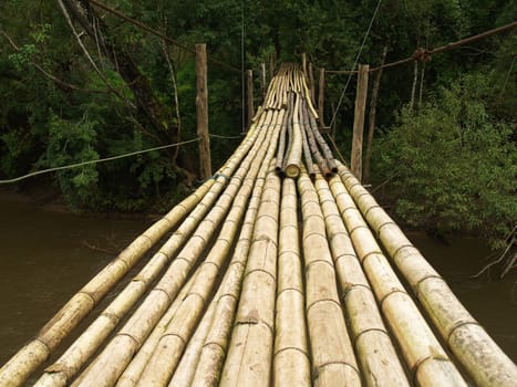 Hanging bamboo bridge over river