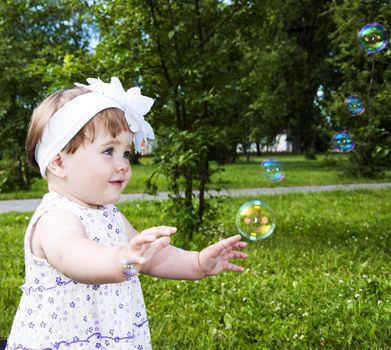 Portrait of the girl playing with soap bubbles