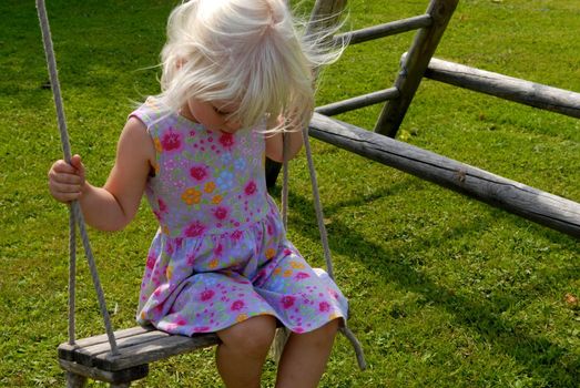 girl playing on the swing. Please note: No negative use allowed.
