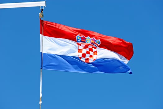 Croatian flag on the ship in front of the blue sky