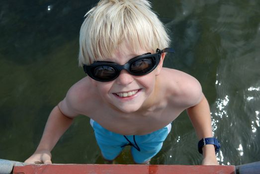 a smiling boy with sun glass. Please note: No negative use allowed.