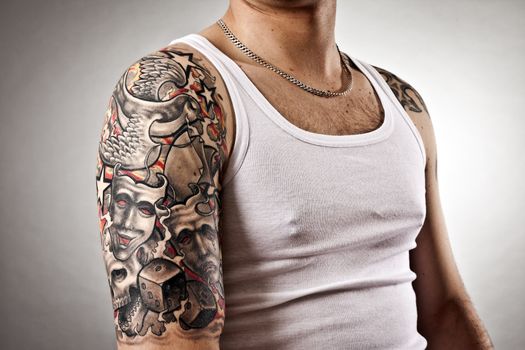 An image of a handsome man with tattoos