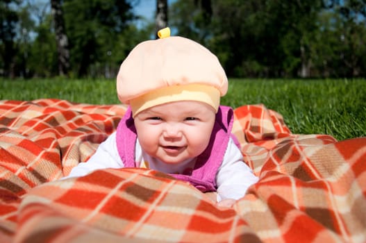 The portrait of the kid, lays on on a coverlet