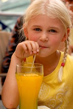 a girl is drinking juice. Please note: No negative use allowed.