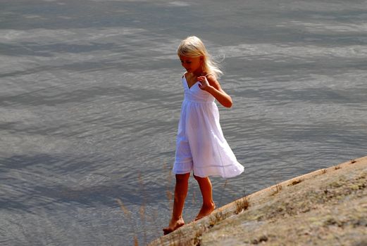 girl playing by the seaside. Please note: No negative use allowed.