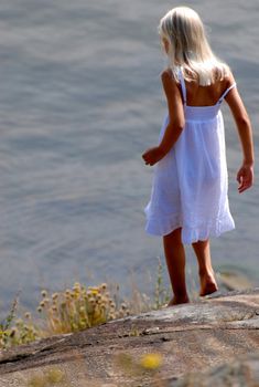 girl playing by the seaside. Please note: No negative use allowed.