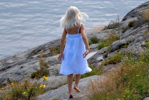 girl playing by the seaside. Please note: No negative use allowed.