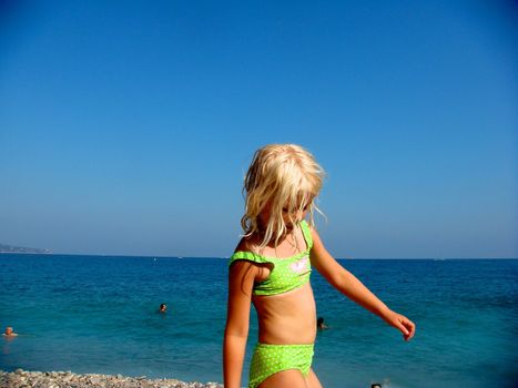 little girl walking on the beach. Please note: No negative use allowed.