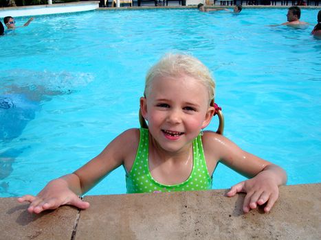 little girl swimming in the pool. Please note: No negative use allowed.