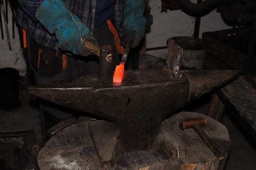 Blacksmith make damascus on anvil in the smithy