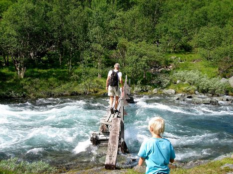 walking on the wooden bridge. Please note: No negative use allowed.