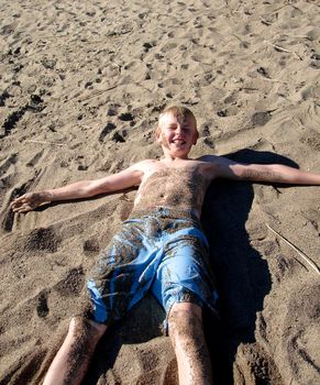 boy having fun on the beach. Please note: No negative use allowed.