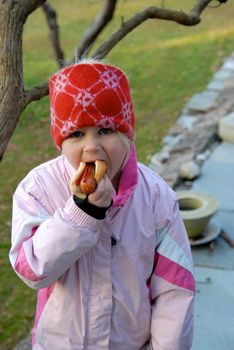 girl eating the hot dog. Please note: No negative use allowed.