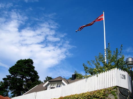 national flag in front of the house. Please note: No negative use allowed.