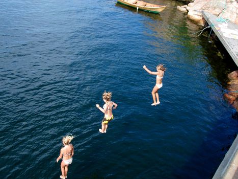 children diving into the sea. Please note: No negative use allowed.