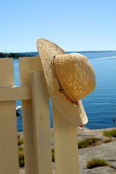 straw hat hanging on the barrier. Please note: No negative use allowed.