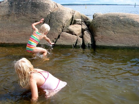girls playing in the sea. Please note: No negative use allowed.