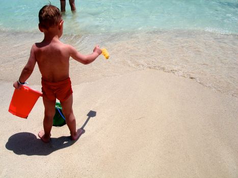 little child playing at the seaside. Please note: No negative use allowed.