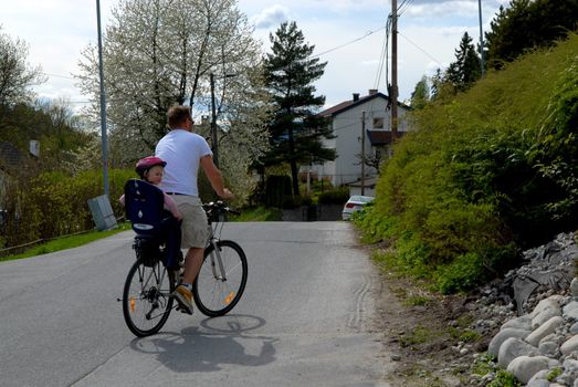 father and daughter ride the bike. Please note: No negative use allowed.