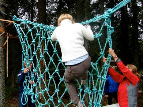 boy climbing the net