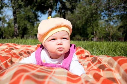 The portrait of the kid, lays on on a coverlet