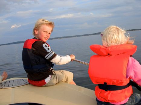 children having fun on boat. Please note: No negative use allowed.