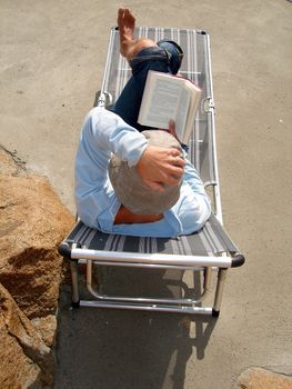 reading a book outdoor. Please note: No negative use allowed.