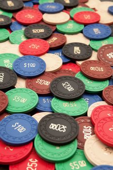 Photo of a large group of poker chips. Focus across the middle.